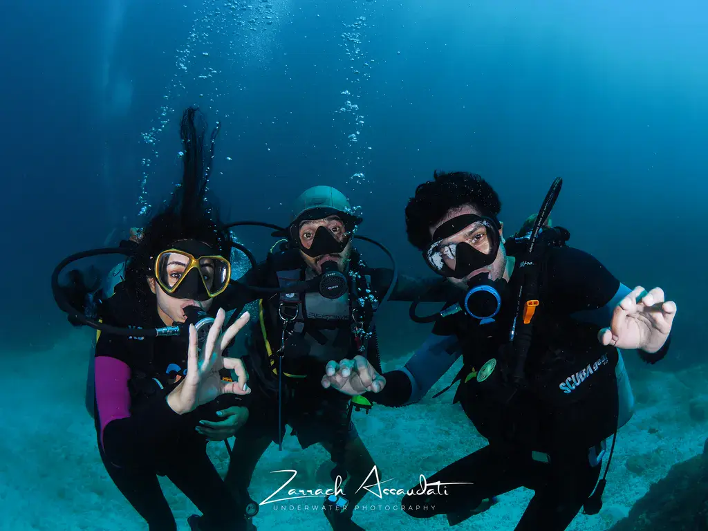 Scuba diving group portrait underwater in Nusa Penida Bali captured by professional dive photographer